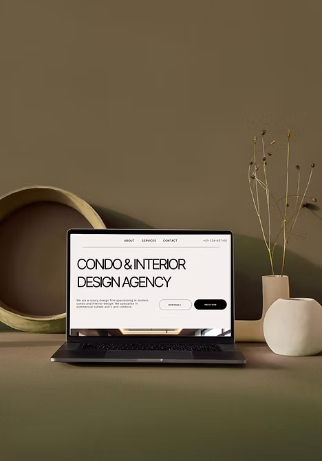 Services 2 condo and interior firm website design on a laptop on a deep green background