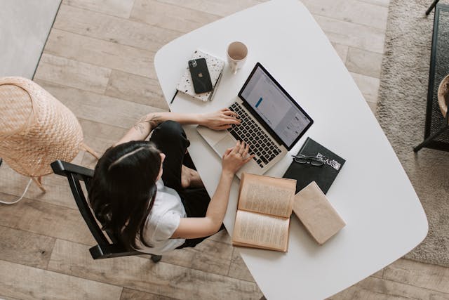 a woman at a white desk trying to rank a one page website on Google